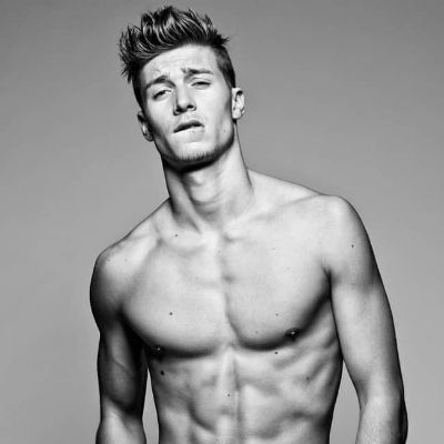 He is topless in the picture showing his ripped body.